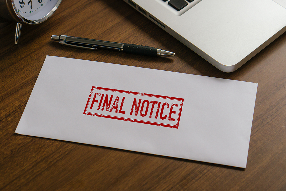 Past-due Final Notice envelope from a debt collector on an office desk